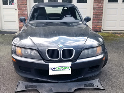 Black BMW sedan broken windshield before repair