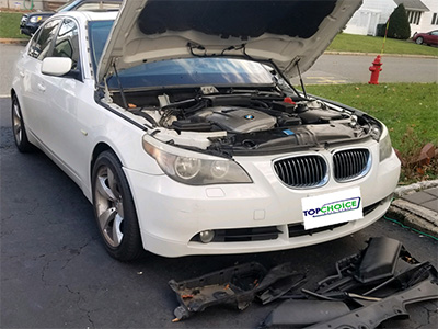 White luxury BMW front windshield repair before replacement by our techs